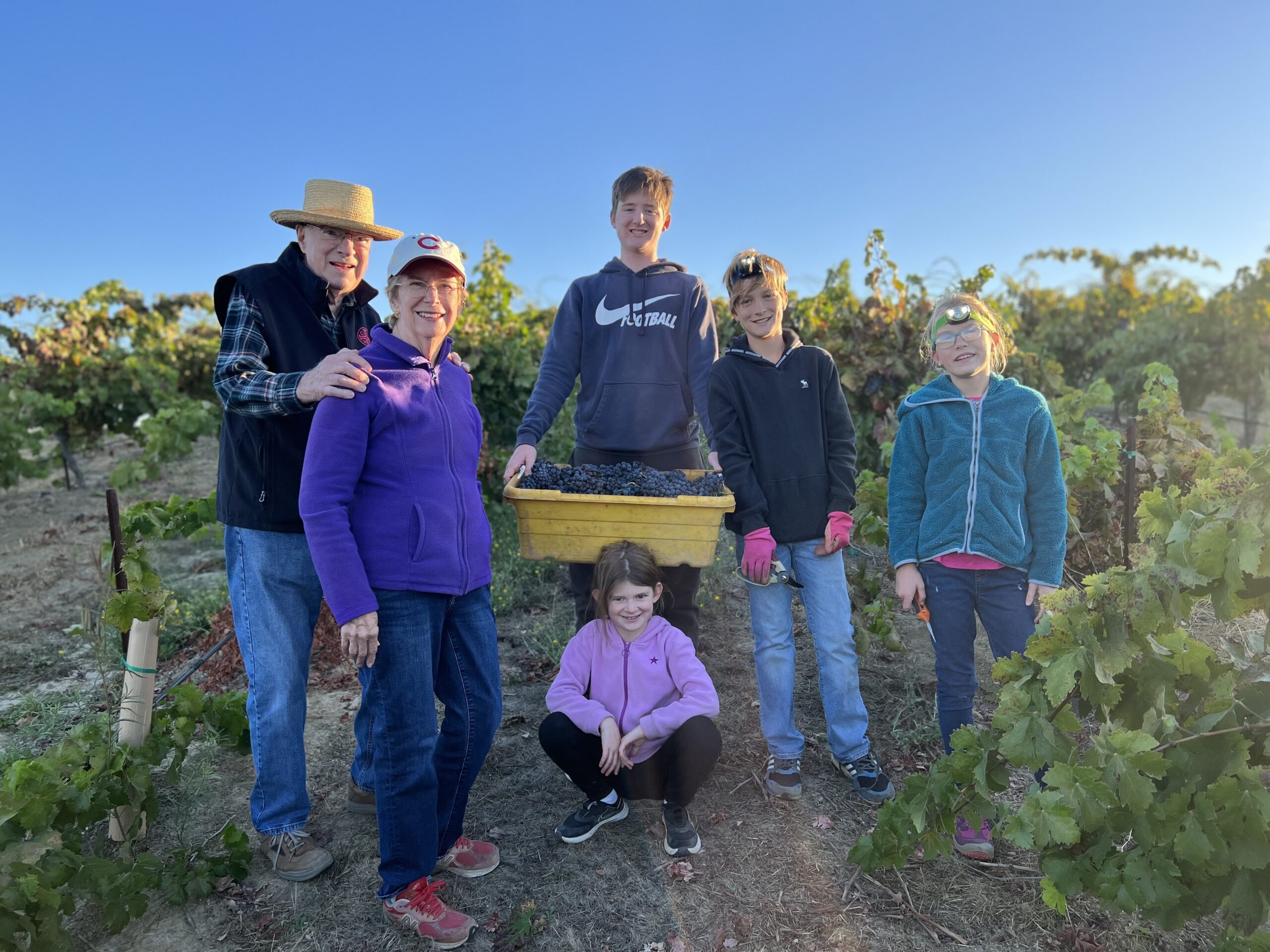 Family group enjoying a vineyard tour at Glunz Family Winery, California.